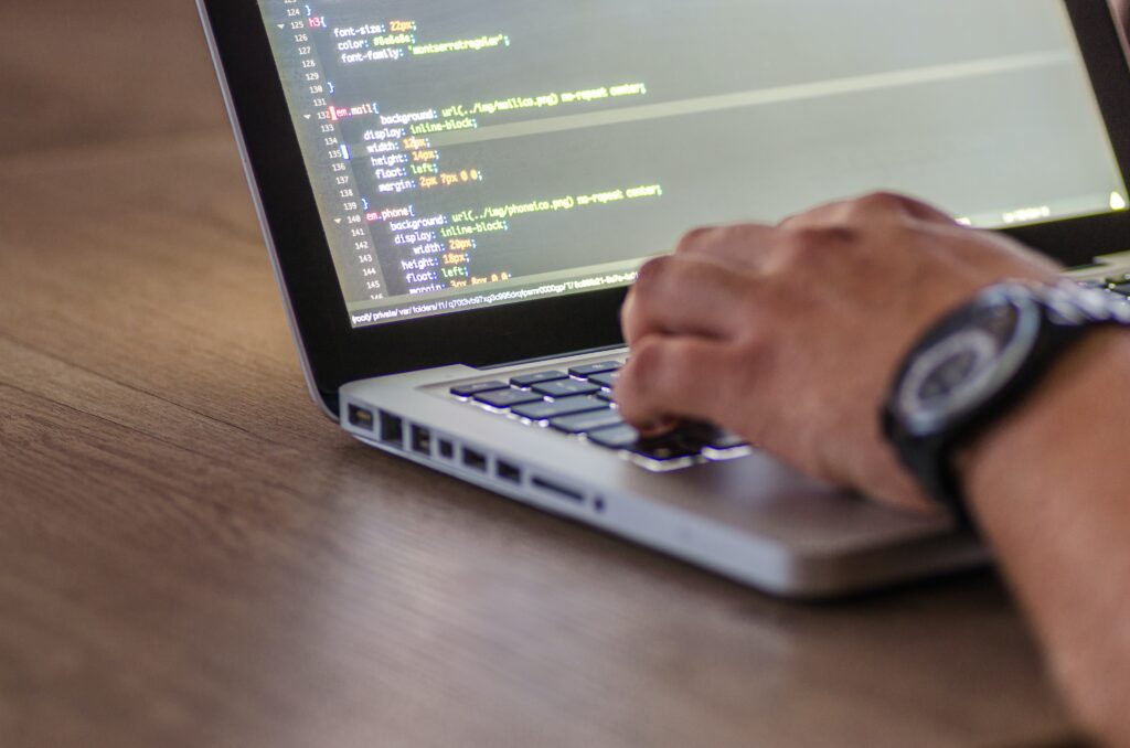 Software Developer writing code on laptop